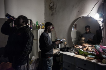 Ali and Moussa spend a lot of their time at the ground floor of the orange building. His small kiosk is the only one among the various informal kiosks scattered around Ex MOI. Turin.