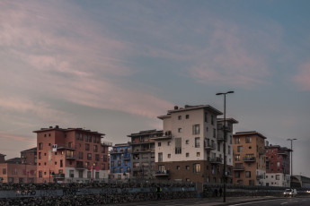 The ex-MOI has always been a problem for the municipality of Turin. No administration has proved capable of managing this complex and delicate situation. The occupation has been fiercely criticised. The various political factions that have alternated over time have always called for the occupants to be evicted without regard for their needs. In reality, however, this place is a city within a city, a place where hundreds of lives intertwine, merge and mingle, creating a cultural landscape of rare beauty. Turin.