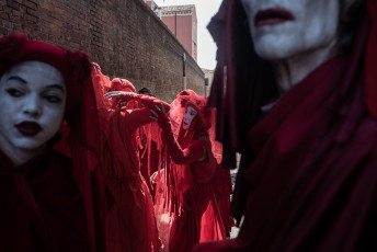 The Red Rebel Brigade was created by Doug Francisco and Justine Squire of Bristol's Invisible Circus for the Extinction Rebellion spring uprising in April 2019 in London. These ethereal otherworldly beings came from a slow-motion mime show called Blanco that the Invisible Circus theatre group toured for many years as a street show in the 1990s. Red Rebel Brigade is an evolution of these ghostly all-white characters that were first developed for the war demonstrations against Iraq in 2003. Venice, July 11, 2021.